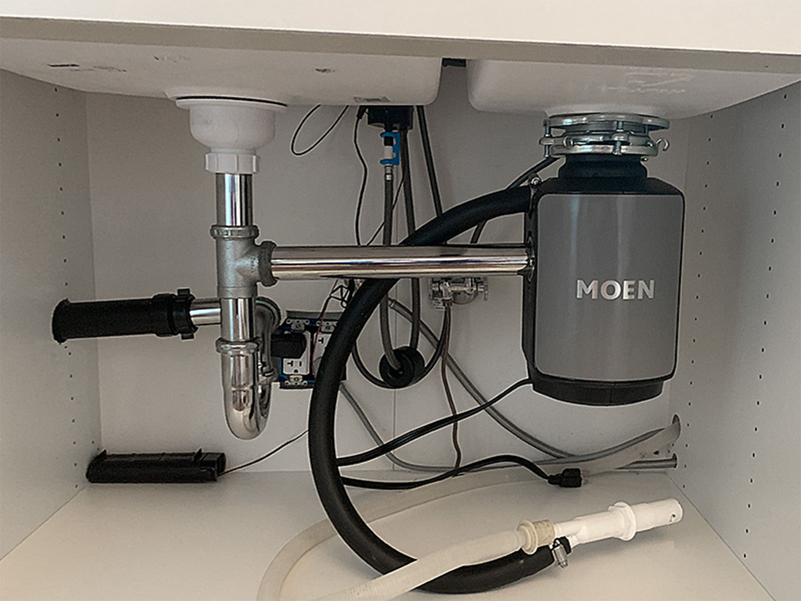 Kitchen plumbing overhaul including new sink base cabinet, complete drain and supply line replacement, and professional garbage disposal installation with proper electrical hookup